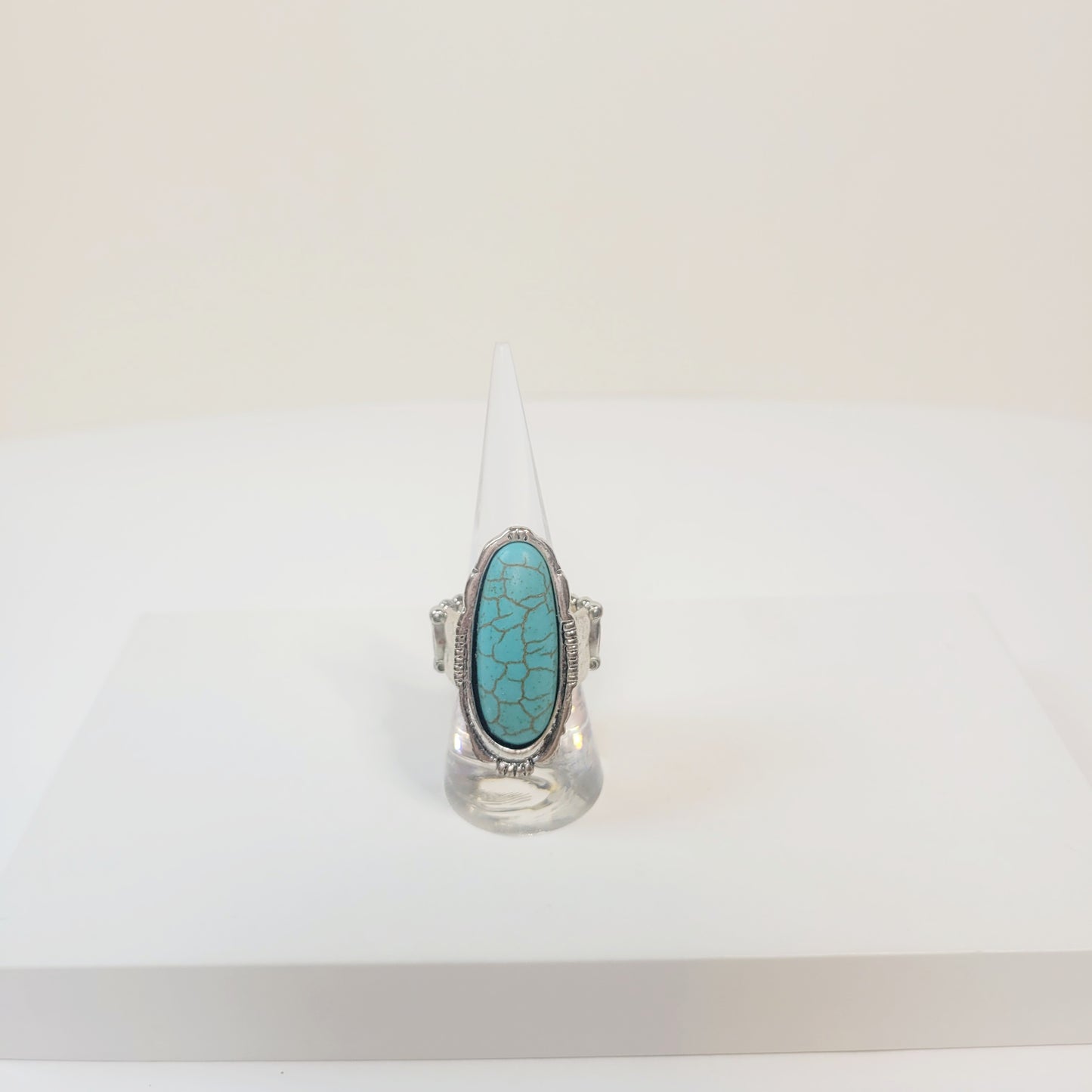 Oval Turquoise Ring. Silver-toned and elastic band.