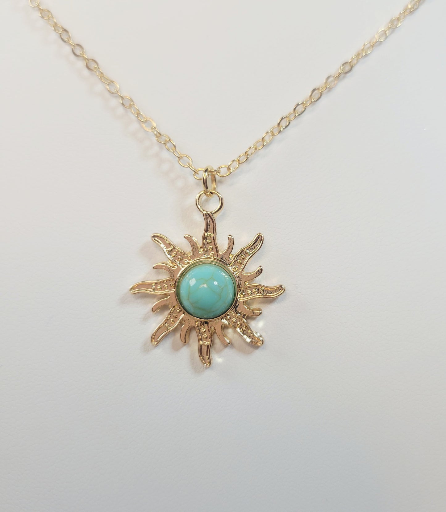 Turquoise Sun Pendant. Gold-toned.